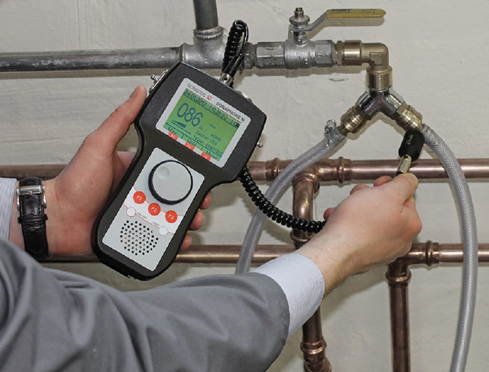 Plumber testing pipes with electronic leak detection equipment in Menifee