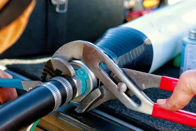 Technician tightening an industrial pipe connection in Menifee