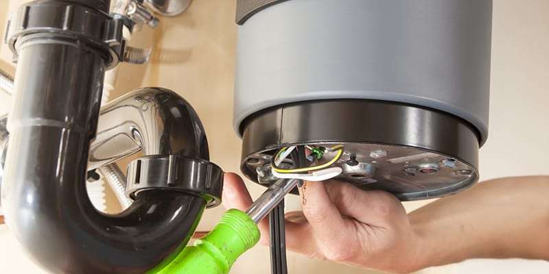 Technician repairing the heating element of a water heater in Menifee
