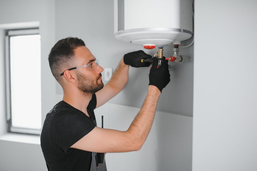 Technician performing water heater maintenance in Menifee